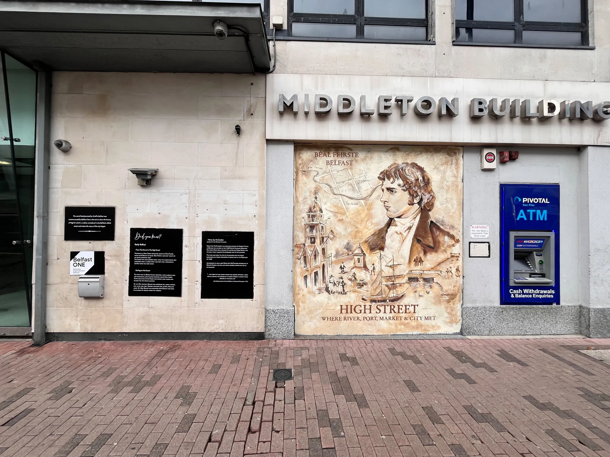 The finished High Street mural on the Middleton Building, flanked by information panels and an ATM.